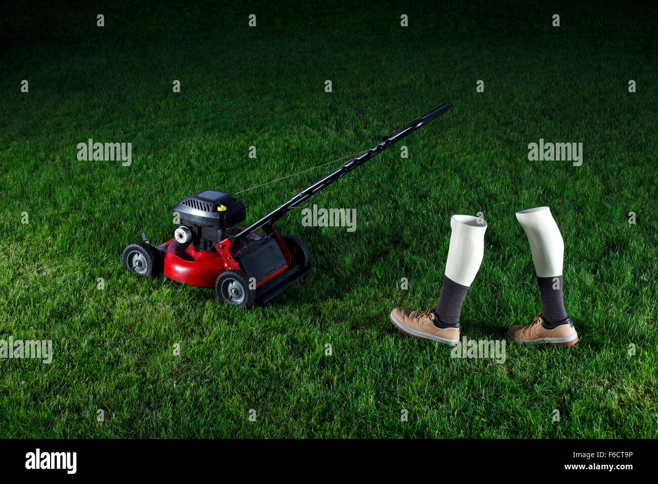 Manikin Legs Mowing a Lawn Stock Photo