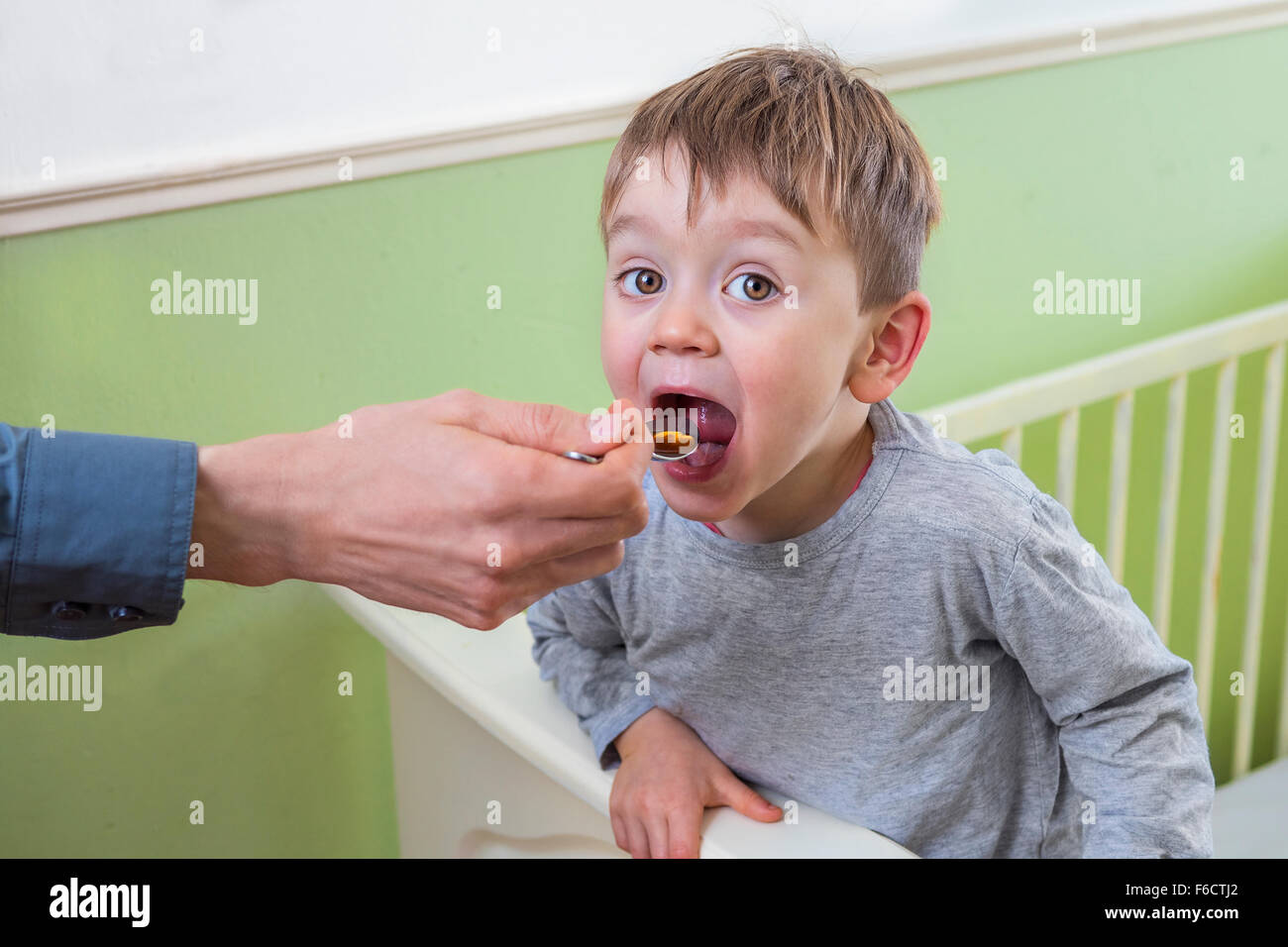 Little boy getting flu medicine Stock Photo