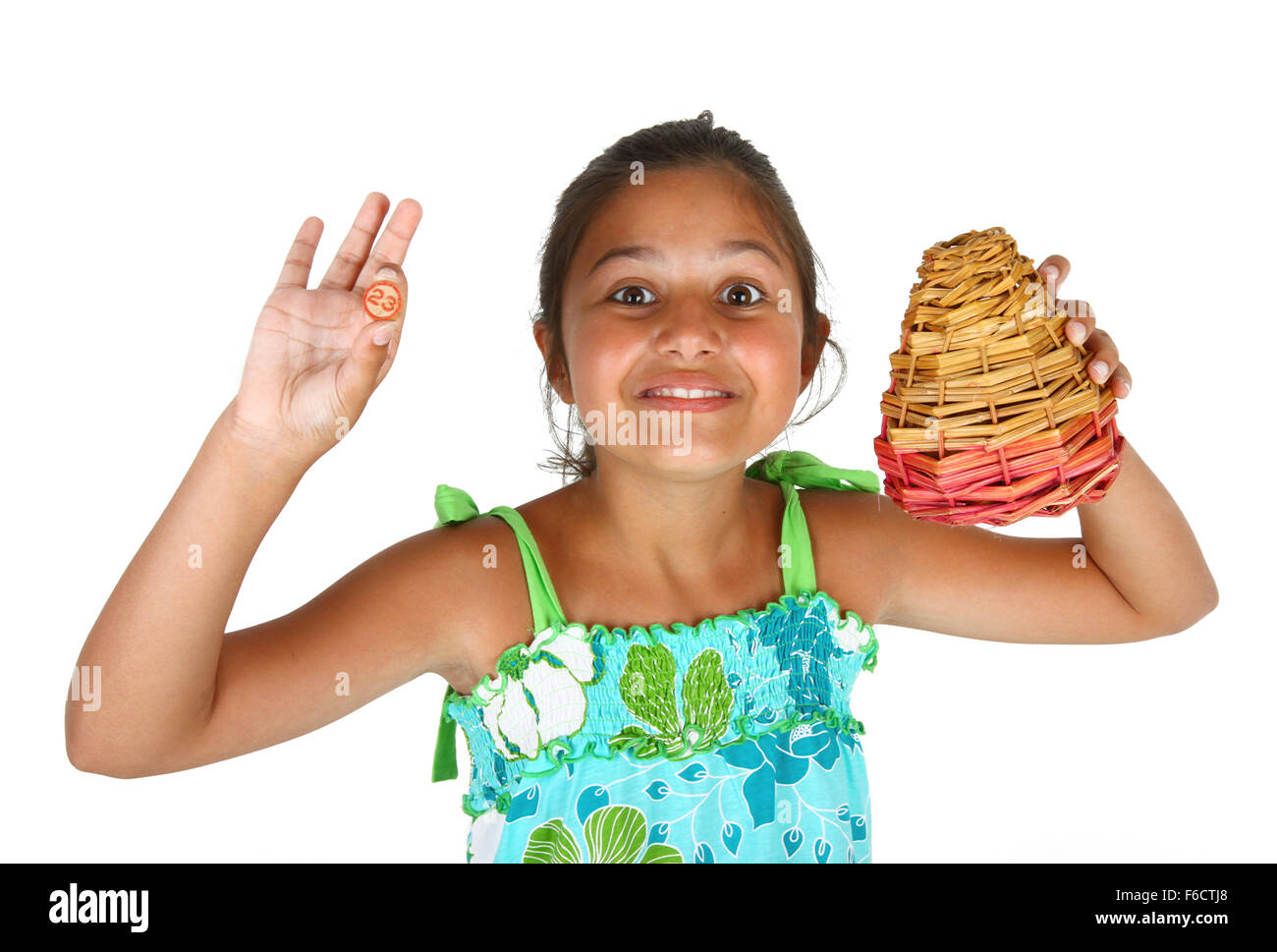 Little girl with basket of numbers for bingo on white background Stock Photo