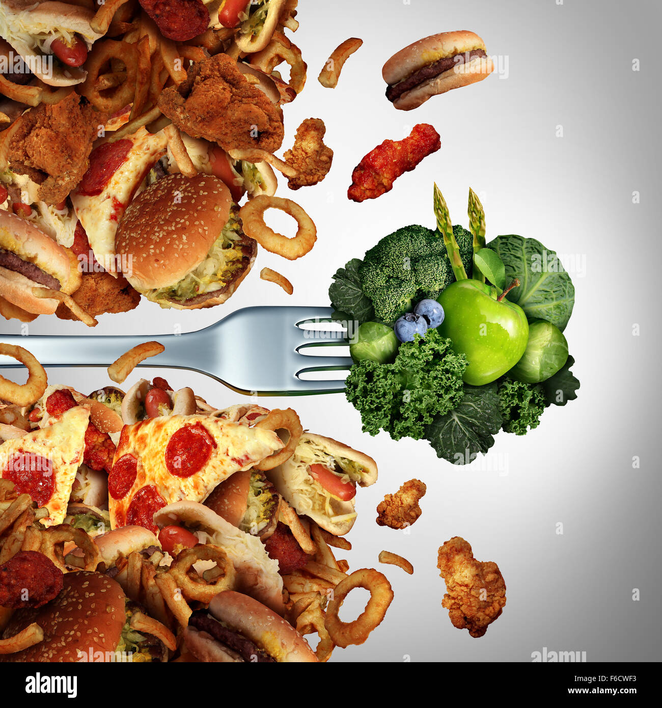 Health diet breakthrough nutrition concept as a fork with green healthy fruits and vegetables breaking through a wall of greasy Stock Photo
