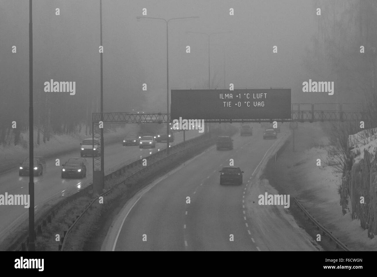 Rush hour traffic in grey and foggy winter evening weather Stock Photo