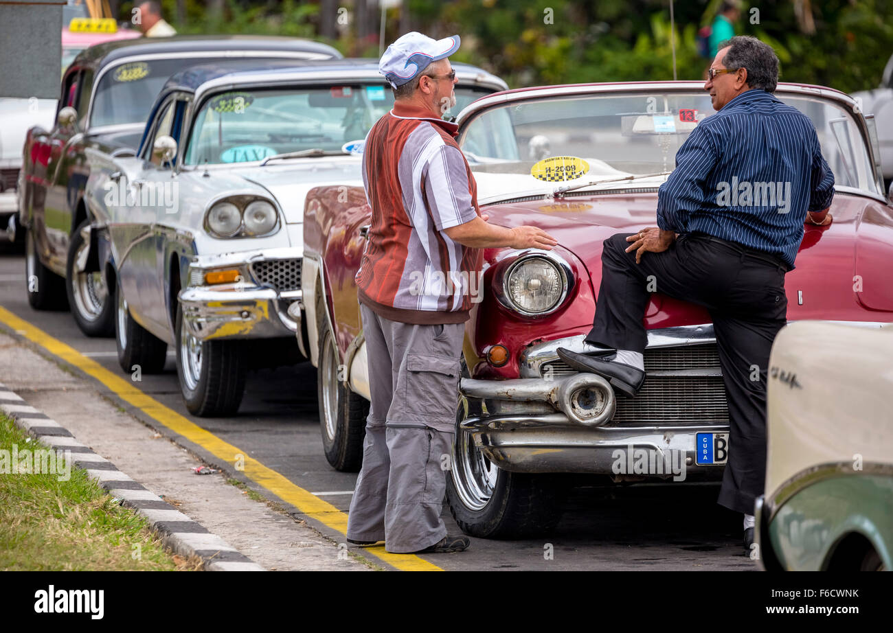 Cuban taxi drivers to their old American limousines, vintage cars on the streets, age, street cruiser, La Habana, Havana, Cuba, Stock Photo