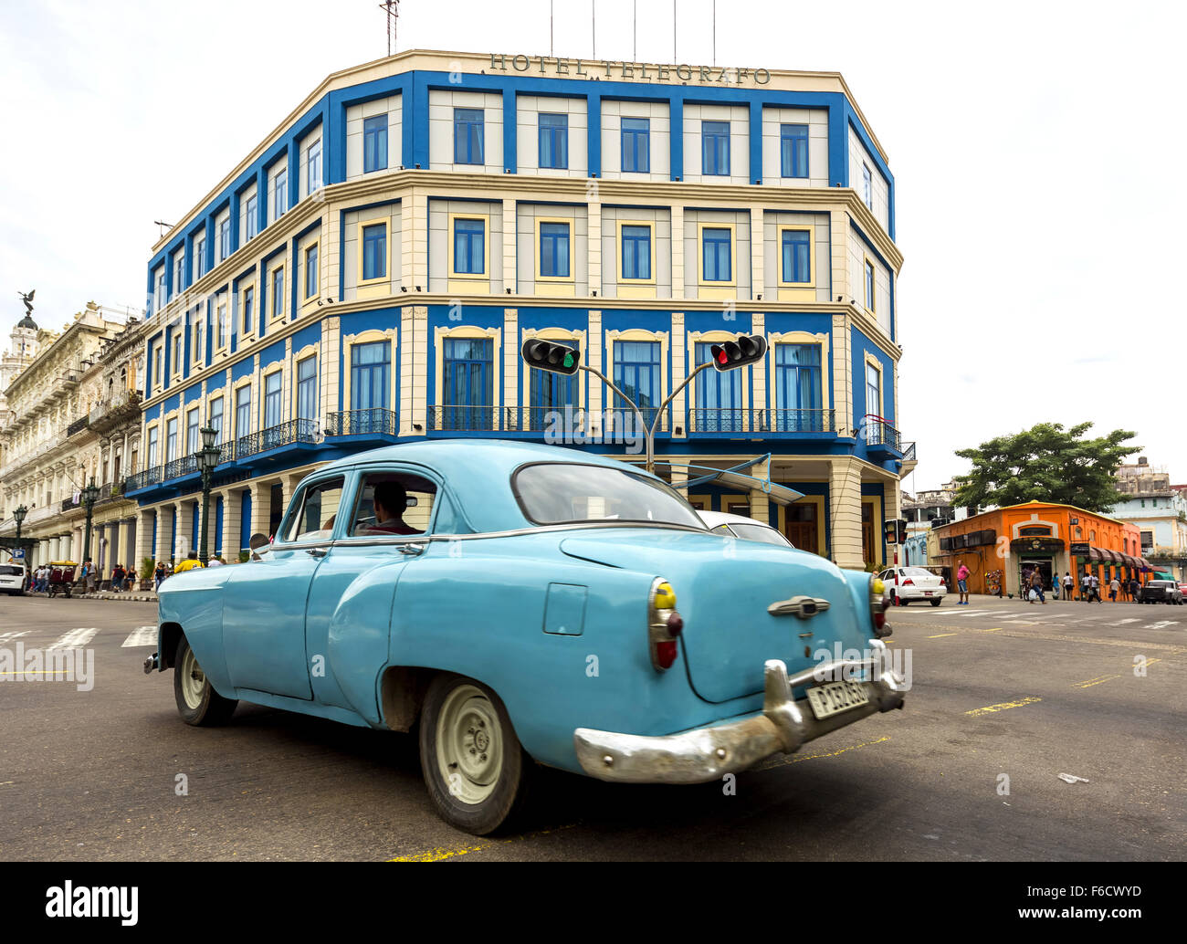 Teal Oldtimer in the street scene, turquoise, old American road cruiser on the streets of Havana, Taxi, Hotel Telegrafo Stock Photo