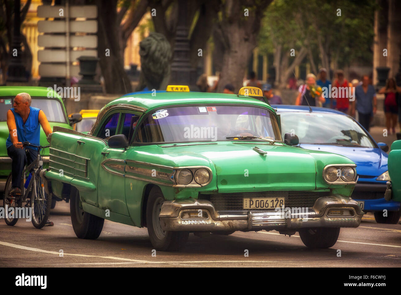 green vintage car in the street scene, old American road cruiser on the streets of Havana, taxi, public transport, La Habana, Stock Photo