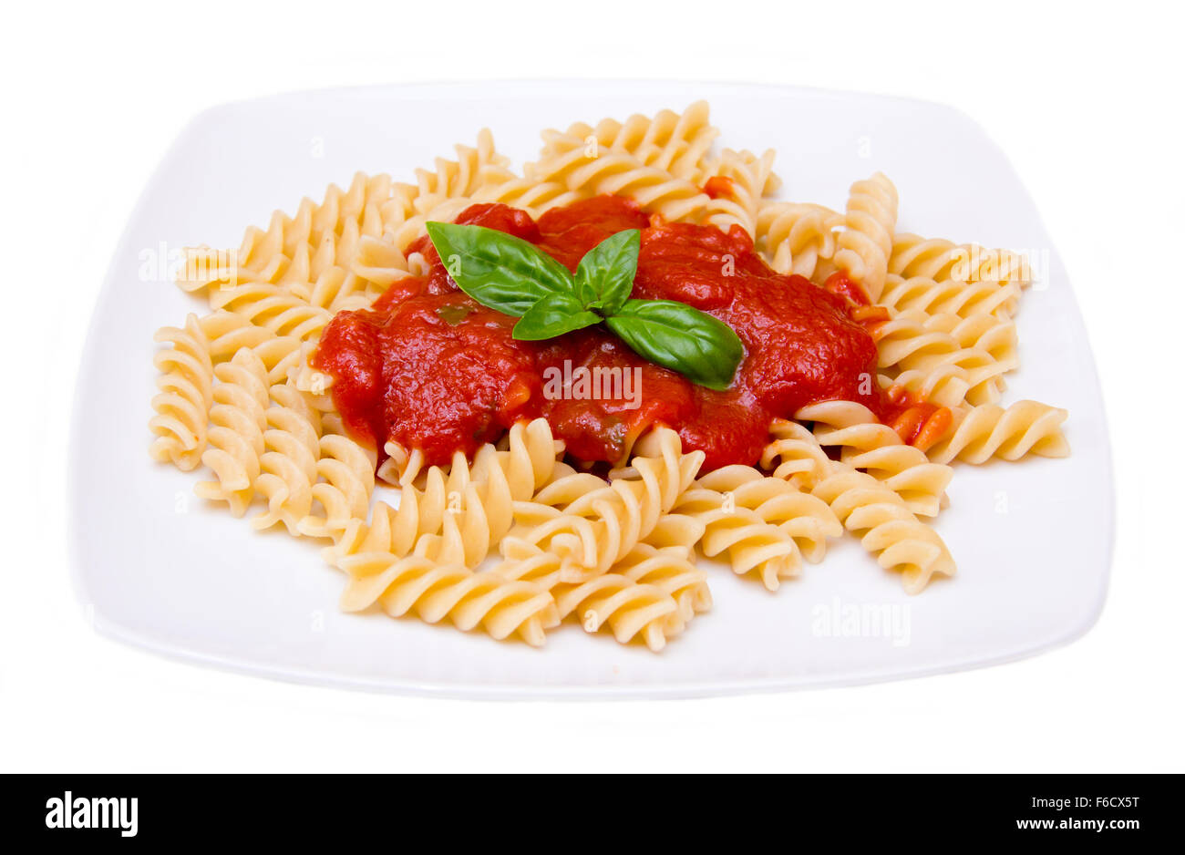 Fusilli with tomato sauce on white background Stock Photo