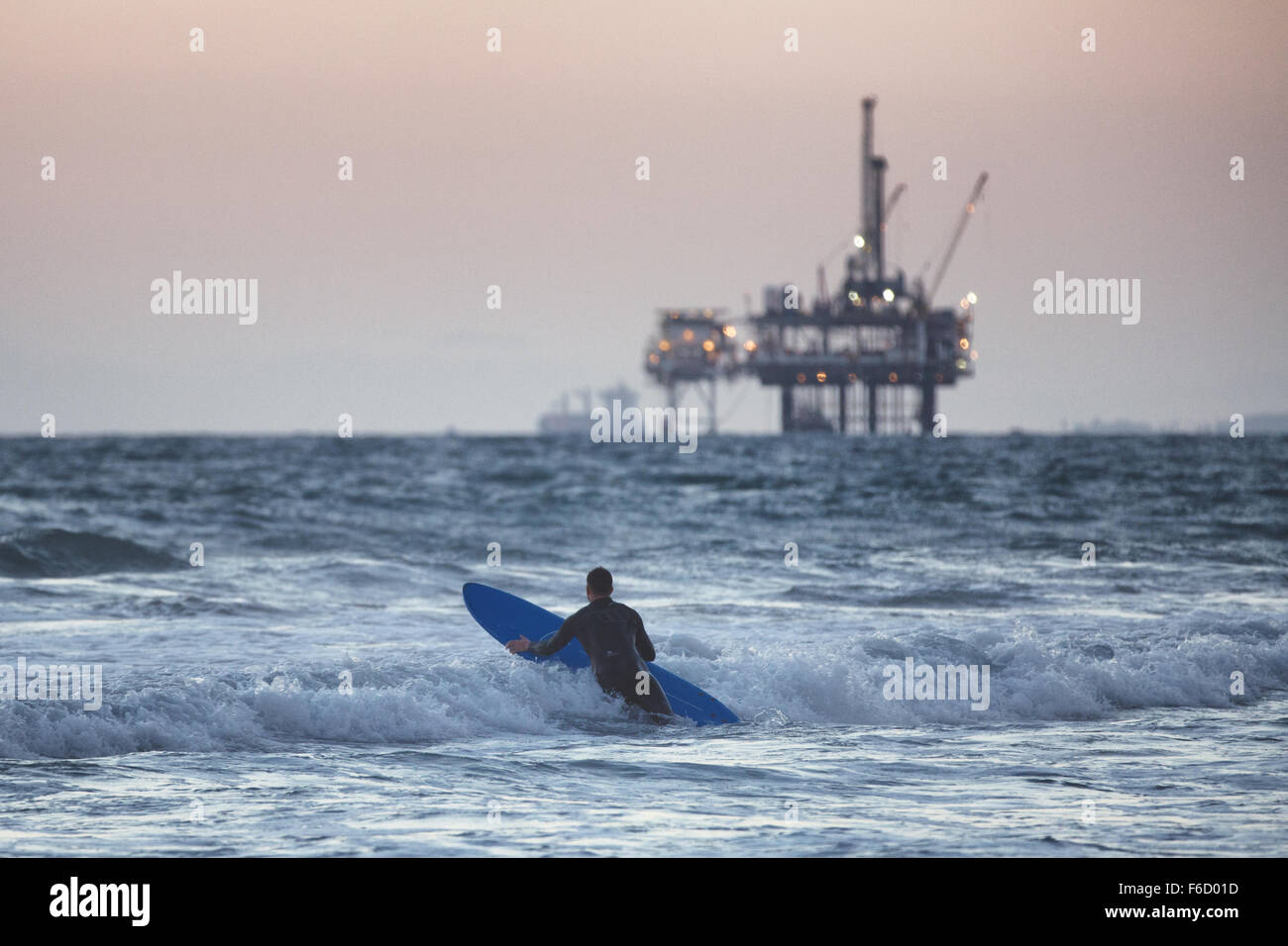 The surfer going into the water. Stock Photo