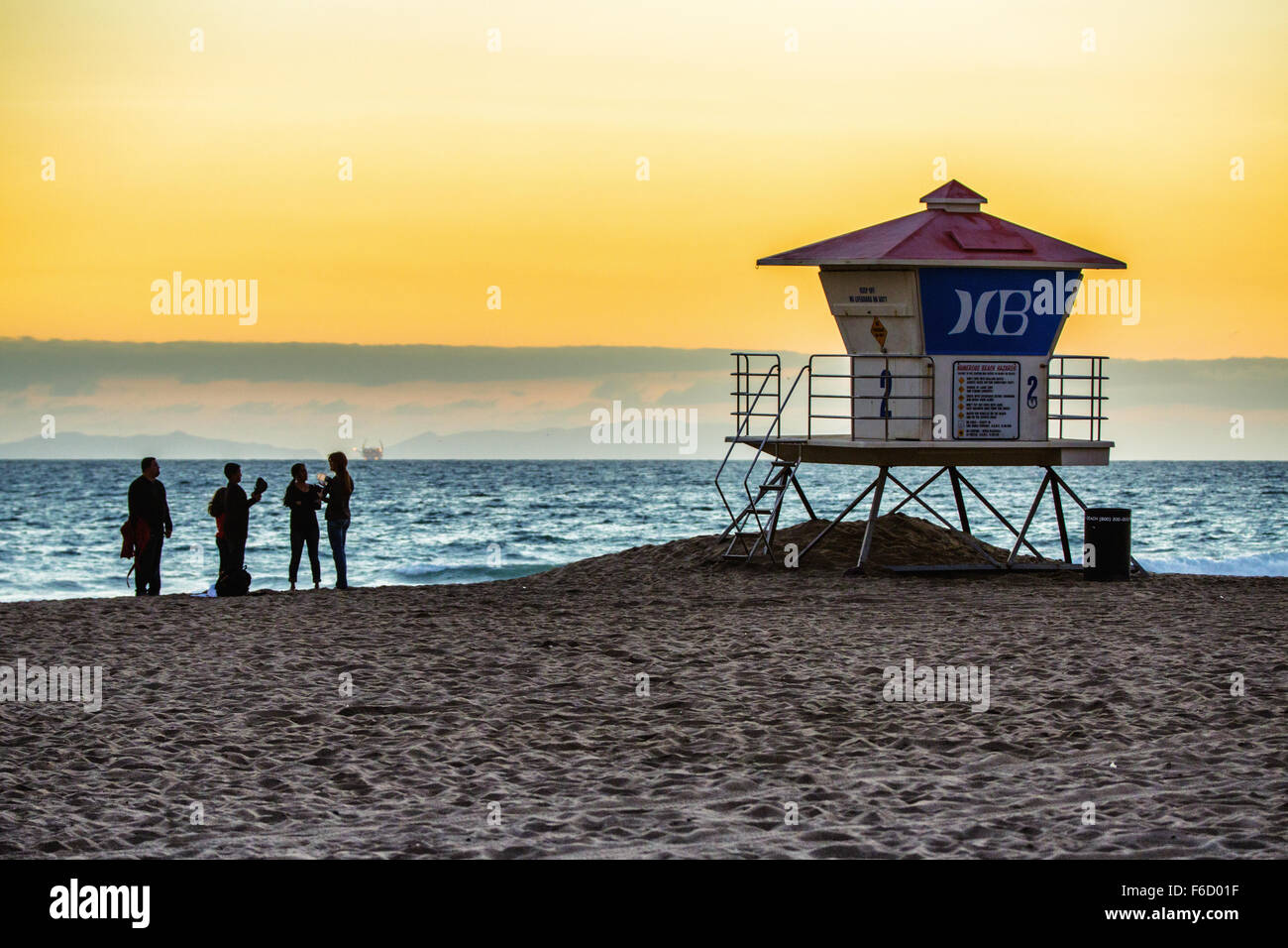 Group of people standing by the lifeguard booth. Stock Photo