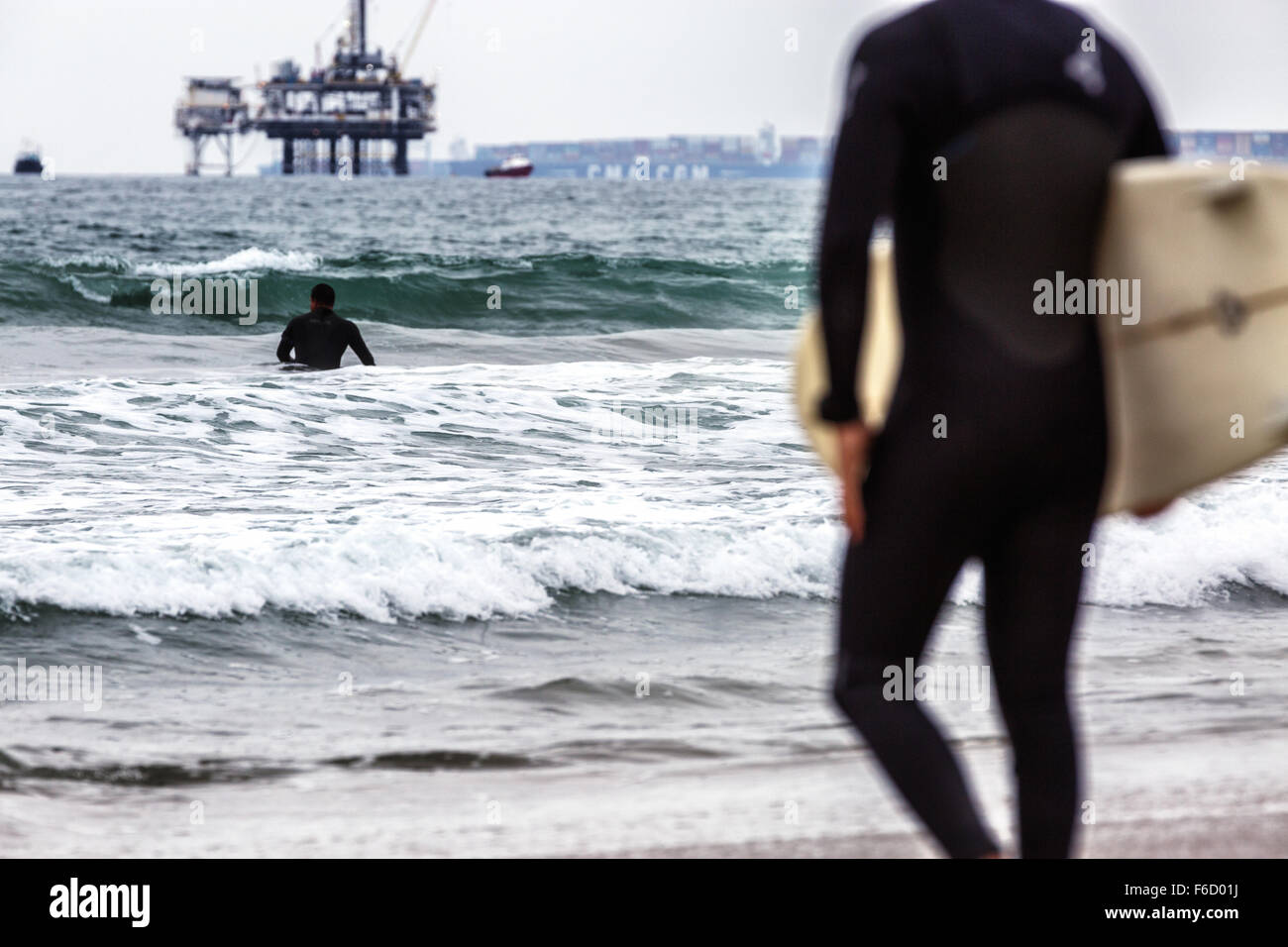 Two surfers going into the water. Stock Photo
