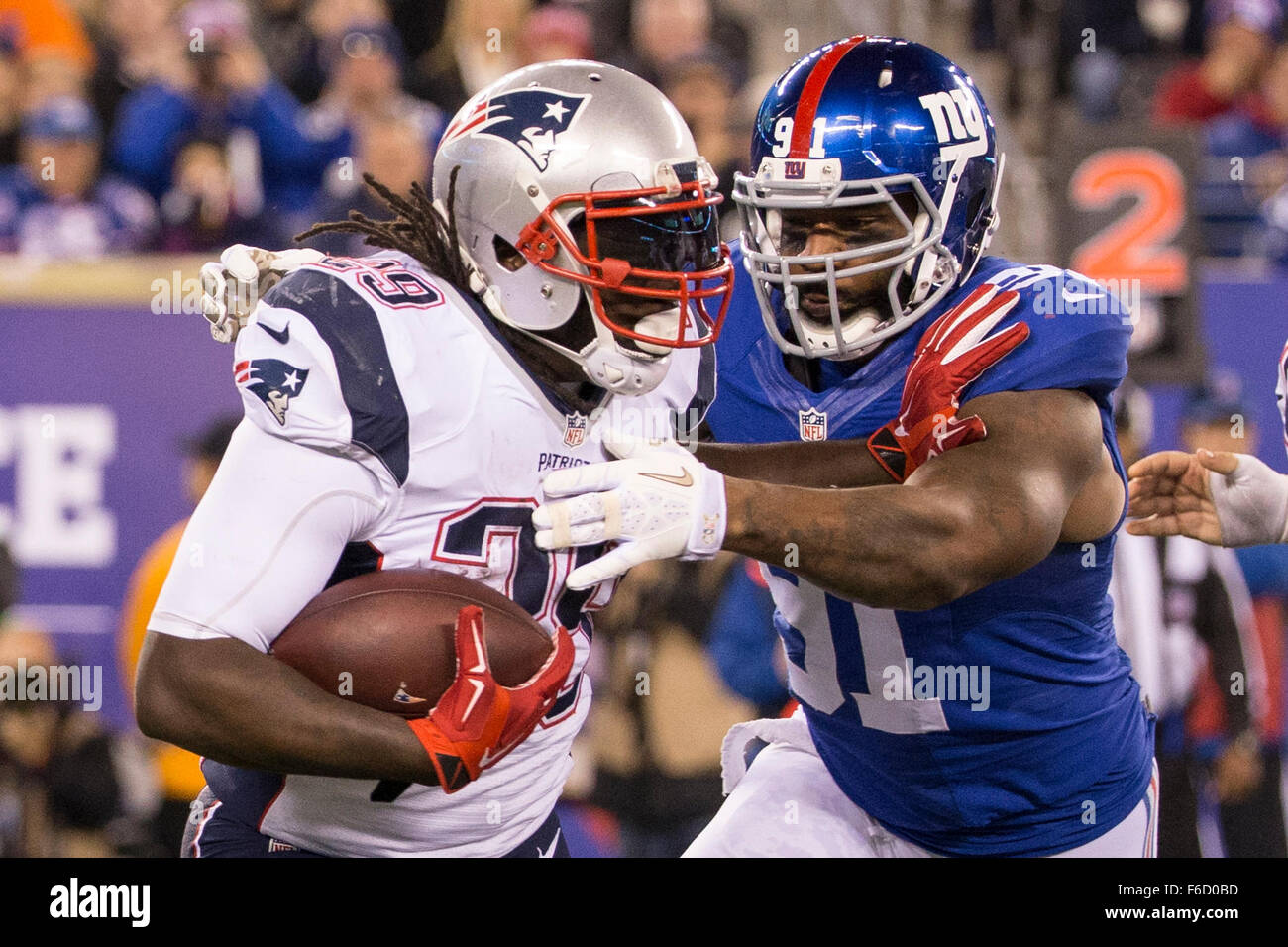 East Rutherford, New Jersey, USA. 15th Nov, 2015. New England Patriots running back LeGarrette Blount (29) runs with the ball as New York Giants defensive end Robert Ayers (91) goes after him during the NFL game between the New England Patriots and the New York Giants at MetLife Stadium in East Rutherford, New Jersey. The New England Patriots won 27-26. Christopher Szagola/CSM/Alamy Live News Stock Photo