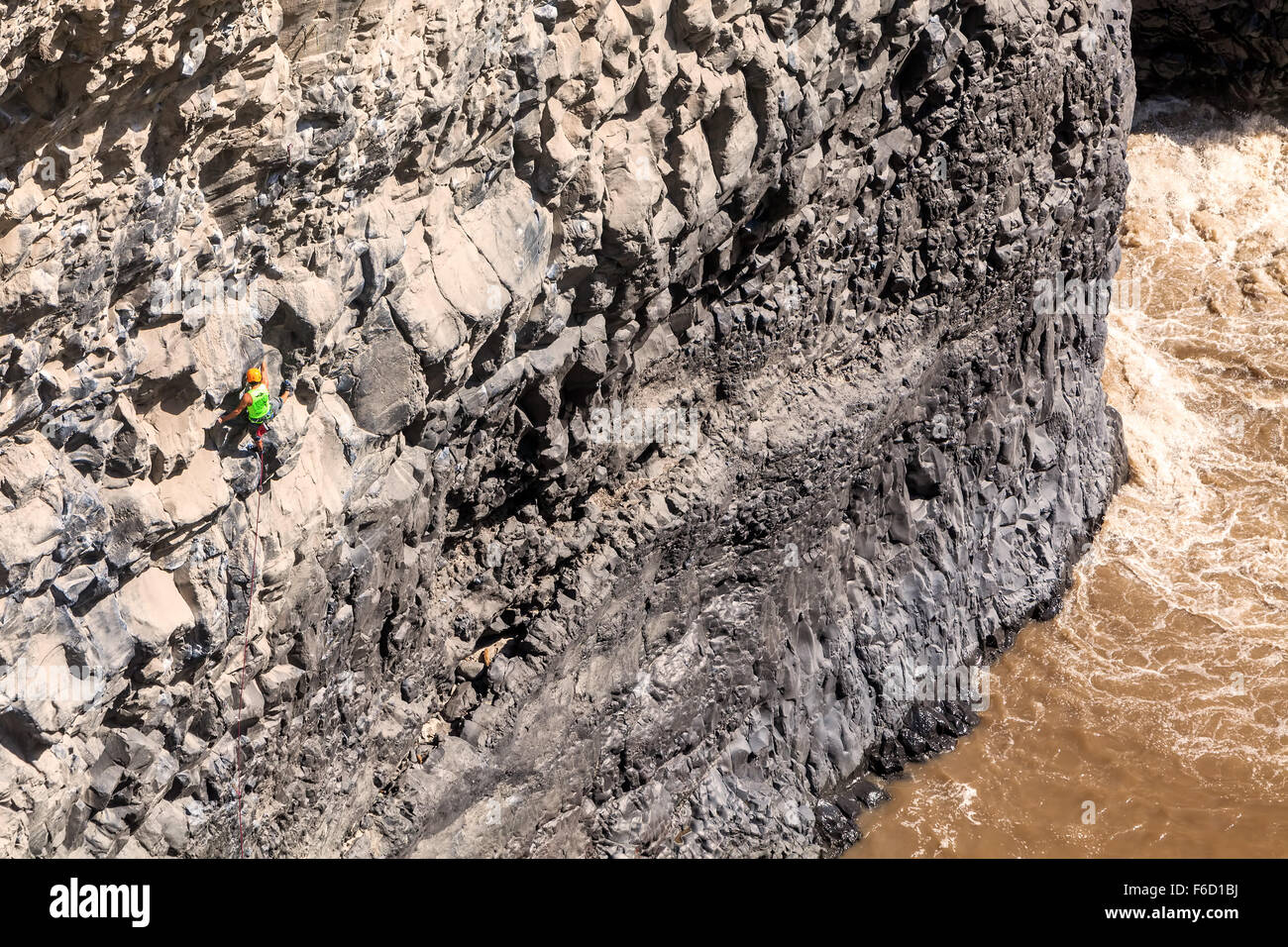 Basalt Challenge Of Tungurahua, Young Brave Man Climbing Natural Rock Wall Stock Photo