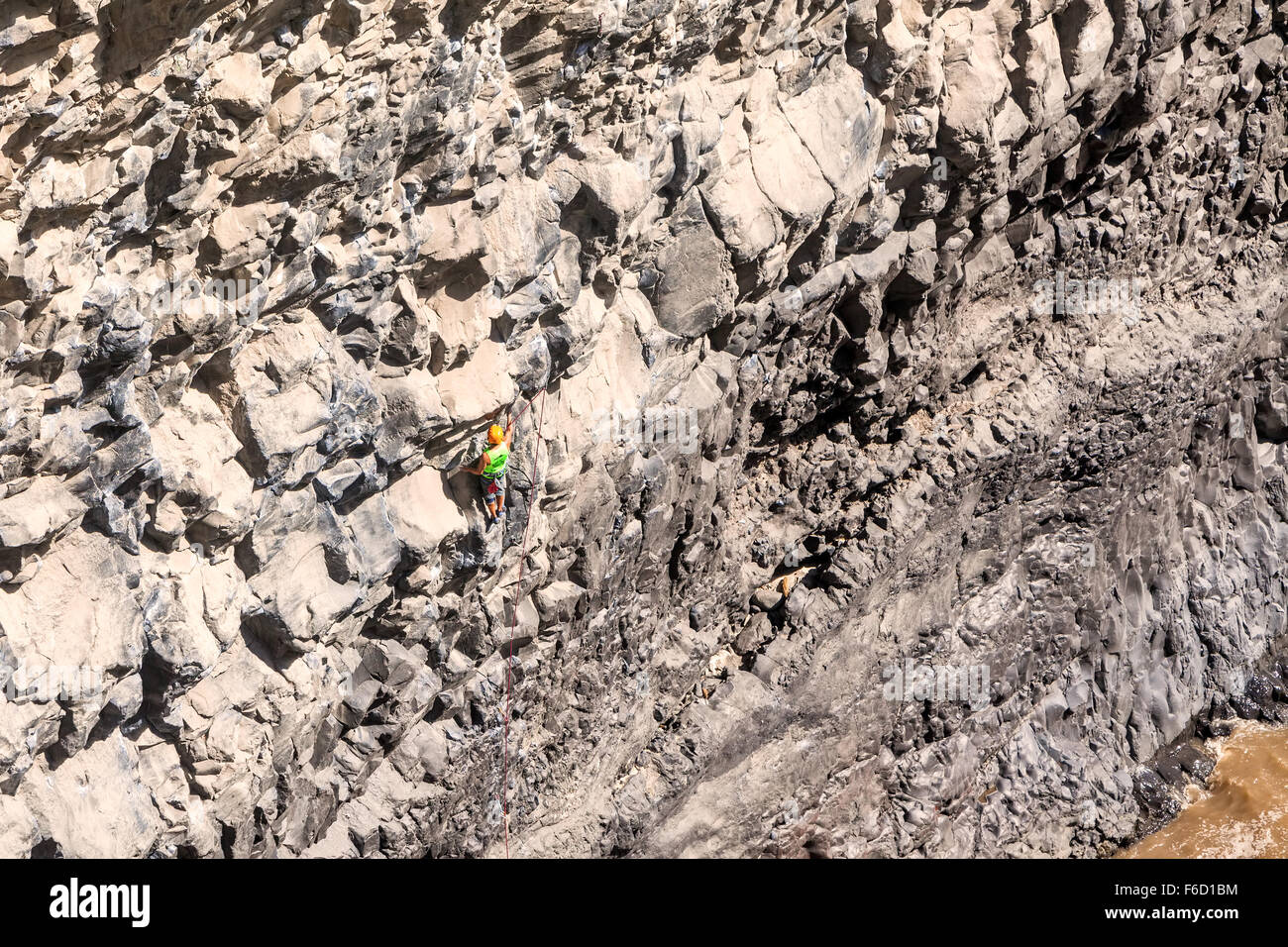 Basalt Challenge Of Tungurahua, Young Courageous Man Climbing Natural Rock Wall Stock Photo