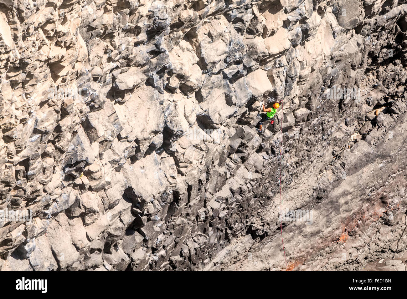 Basalt Challenge Of Tungurahua, Young Man Climbing Natural Rock Wall Stock Photo