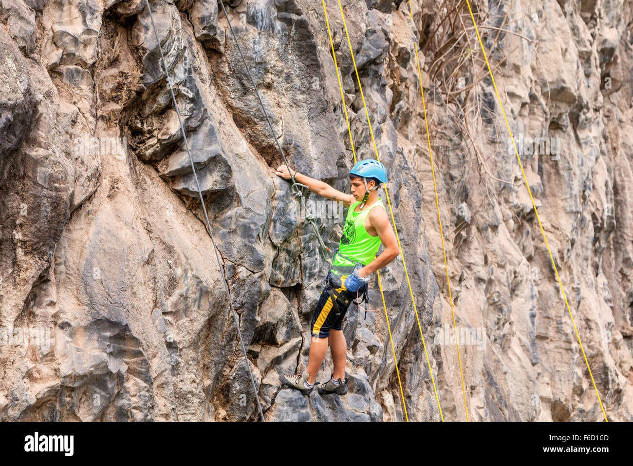 Banos, Ecuador - 30 November 2014: Basalt Challenge Of Tungurahua, Young Hispanic Man Climbing Vertical Rock Wall In Banos Stock Photo