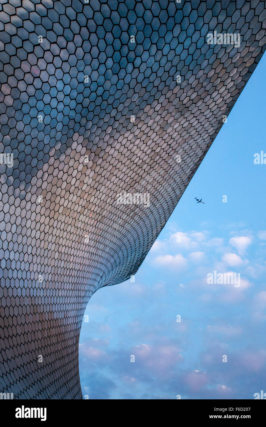 Airplane flies over the modern Soumaya Art Museum of Art in Mexico City, Mexico. Stock Photo
