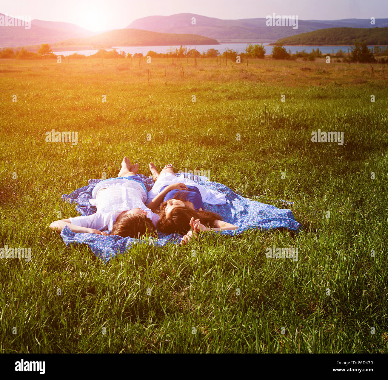Young couple lying on the grass Stock Photo - Alamy