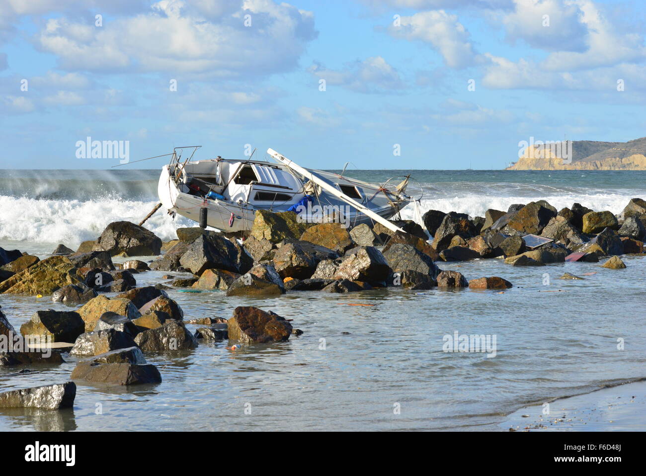 A Yacht being ship wrecked on the rocks on the beach at San Diego ...
