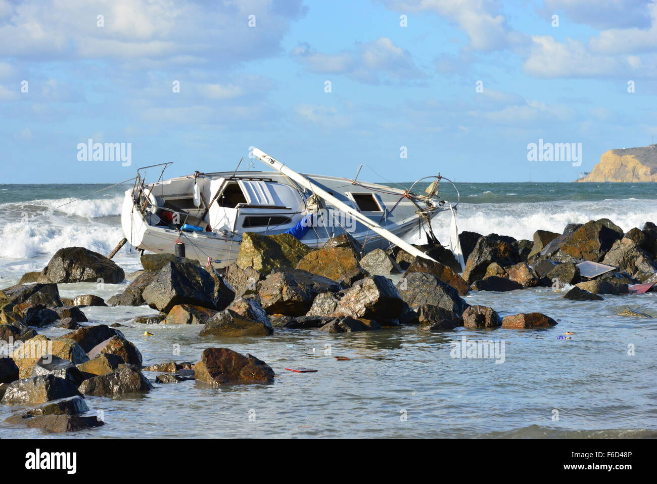 A Yacht being ship wrecked on the rocks on the beach at San Diego ...