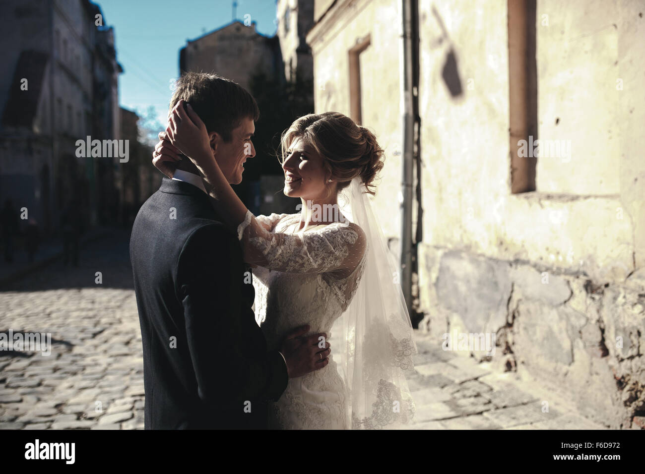 bride and groom posing on the streets Stock Photo - Alamy