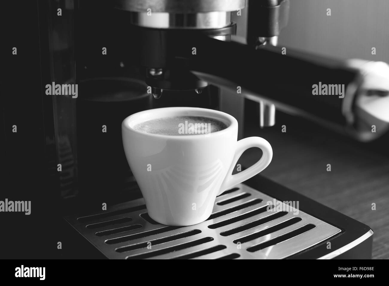 Black and white image of preparing espresso in coffee machine Stock Photo