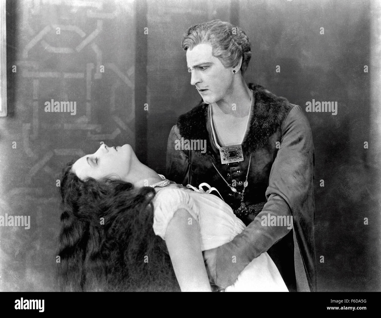 RELEASE DATE: February 19, 1927   MOVIE TITLE: Don Juan   STUDIO: Warner Bros. Pictures   DIRECTOR: Alan Crosland   PLOT: If there was one thing that Don Juan de Marana learned from his father Don Jose, it was that women gave you three things - life, disillusionment and death. In his father's case it was his wife, Donna Isobel, and Donna Elvira who supplied the latter. Don Juan settled in Rome after attending the University of Pisa. Rome was run by the tyrannical Borgia family consisting of Caesar, Lucrezia and the Count Donati. Juan has his way with and was pursued by many women, but it is th Stock Photo