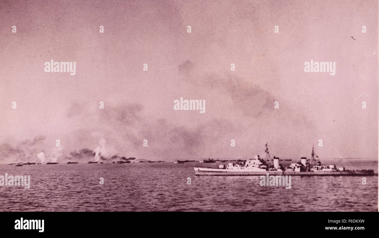 712. Italy. Anzio landings. Cruiser bombarding enemy shore positions as landing craft close into the beaches Stock Photo