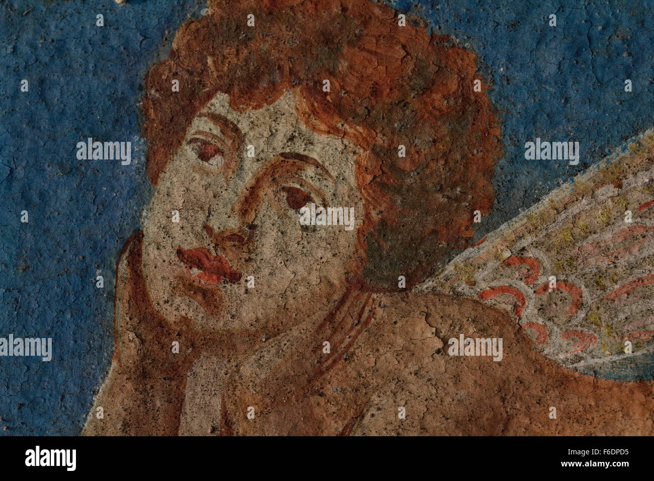 Cracked paint brush strokes of an angel's portrait, from wallpainting entitled 'The spring' by M. Papamalis. Kontias, Lemnos, GR Stock Photo