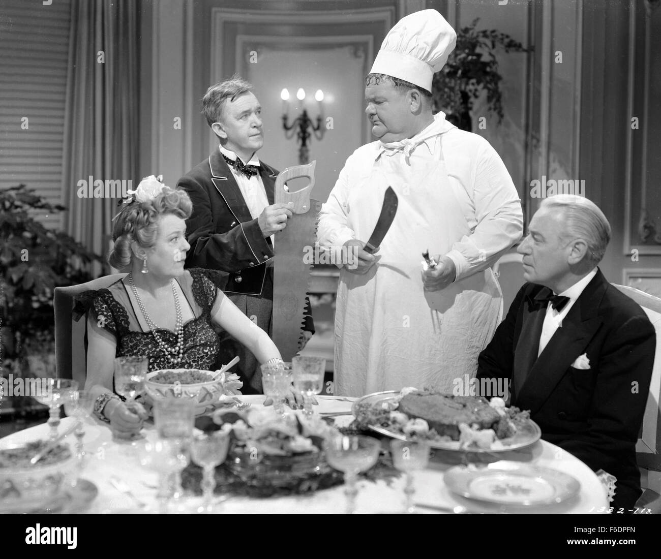 RELEASE DATE: December 6, 1944. MOVIE TITLE: Nothing But Trouble. STUDIO: Metro-Goldwyn-Mayer (MGM). PLOT: Working as chef and butler, the boys wreck a fancy dinner party and, in the process, accidently foil a plot, by enemy agents, to poison a young exiled king. PICTURED: STAN LAUREL as Stan and OLIVER HARDY as Ollie. Stock Photo
