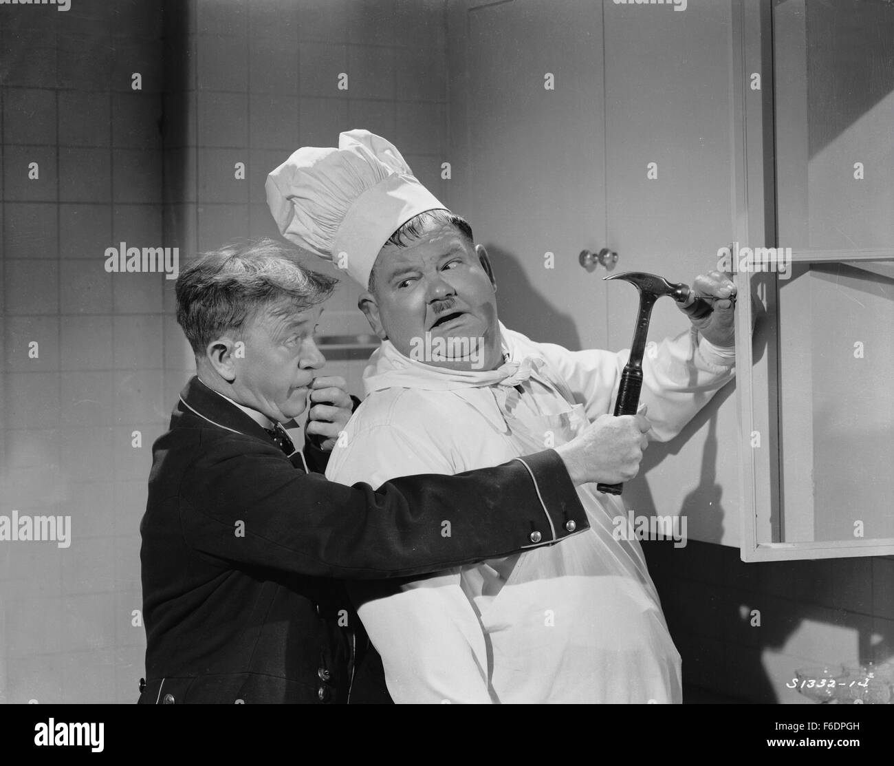 RELEASE DATE: December 6, 1944. MOVIE TITLE: Nothing But Trouble. STUDIO: Metro-Goldwyn-Mayer (MGM). PLOT: Working as chef and butler, the boys wreck a fancy dinner party and, in the process, accidently foil a plot, by enemy agents, to poison a young exiled king. PICTURED: STAN LAUREL as Stan and OLIVER HARDY as Ollie. Stock Photo