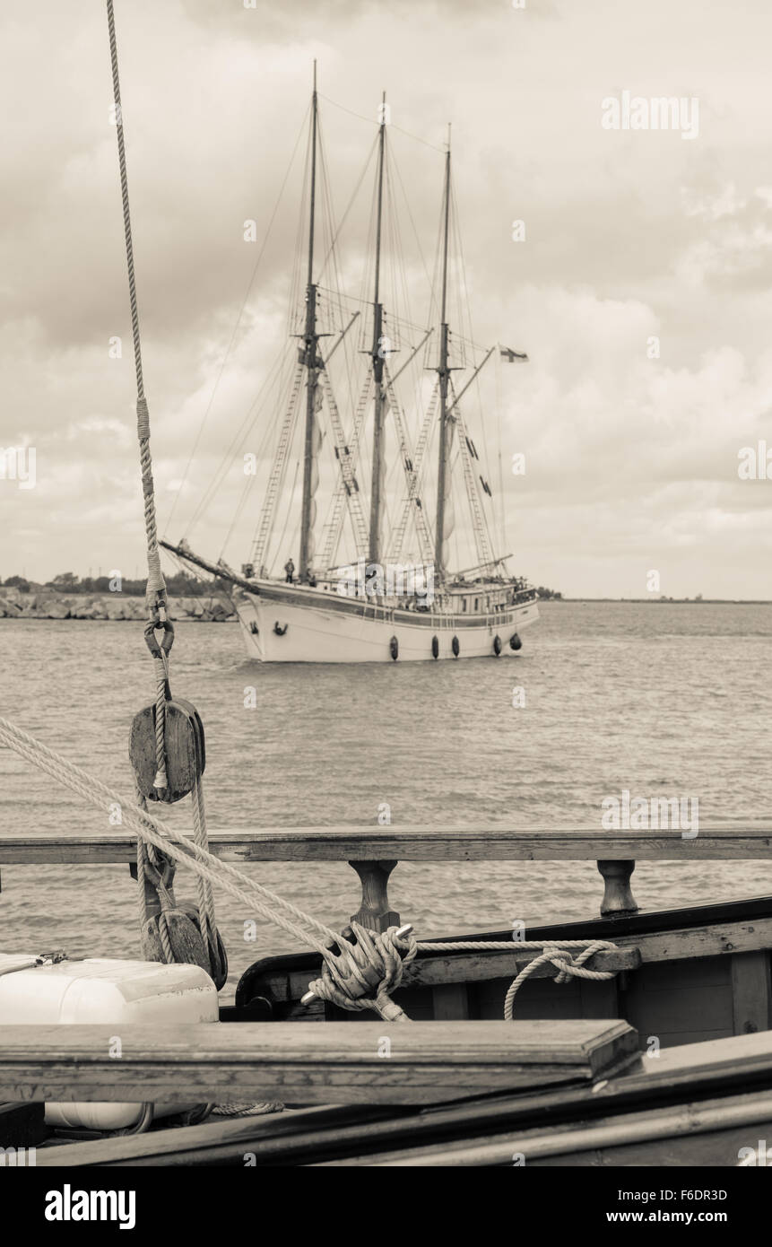 Old sailboat in the harbor, sepia Stock Photo