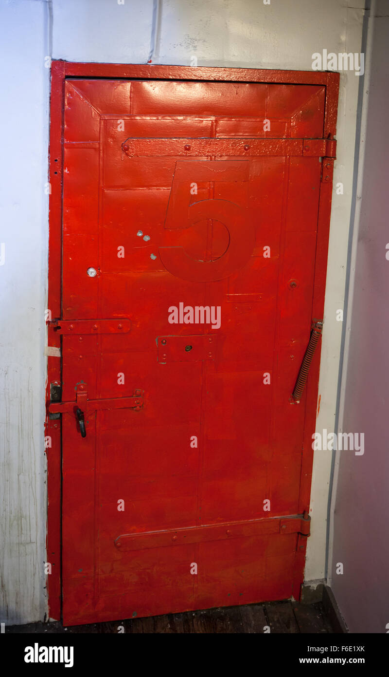 Vintage Fire Door Painted Red With Number Five Stock Photo