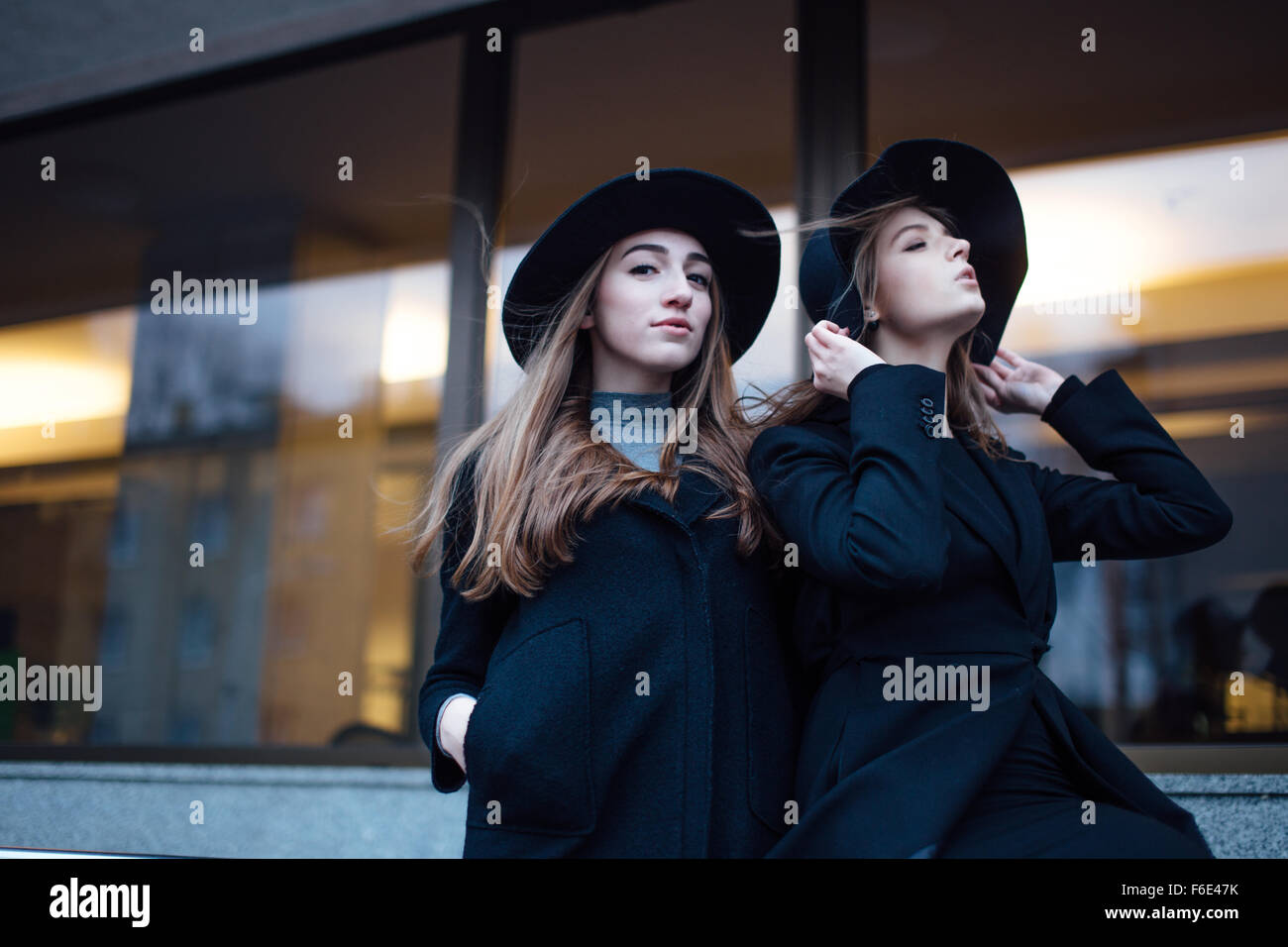 Two young girls walking on the street and posing to camera Stock Photo ...