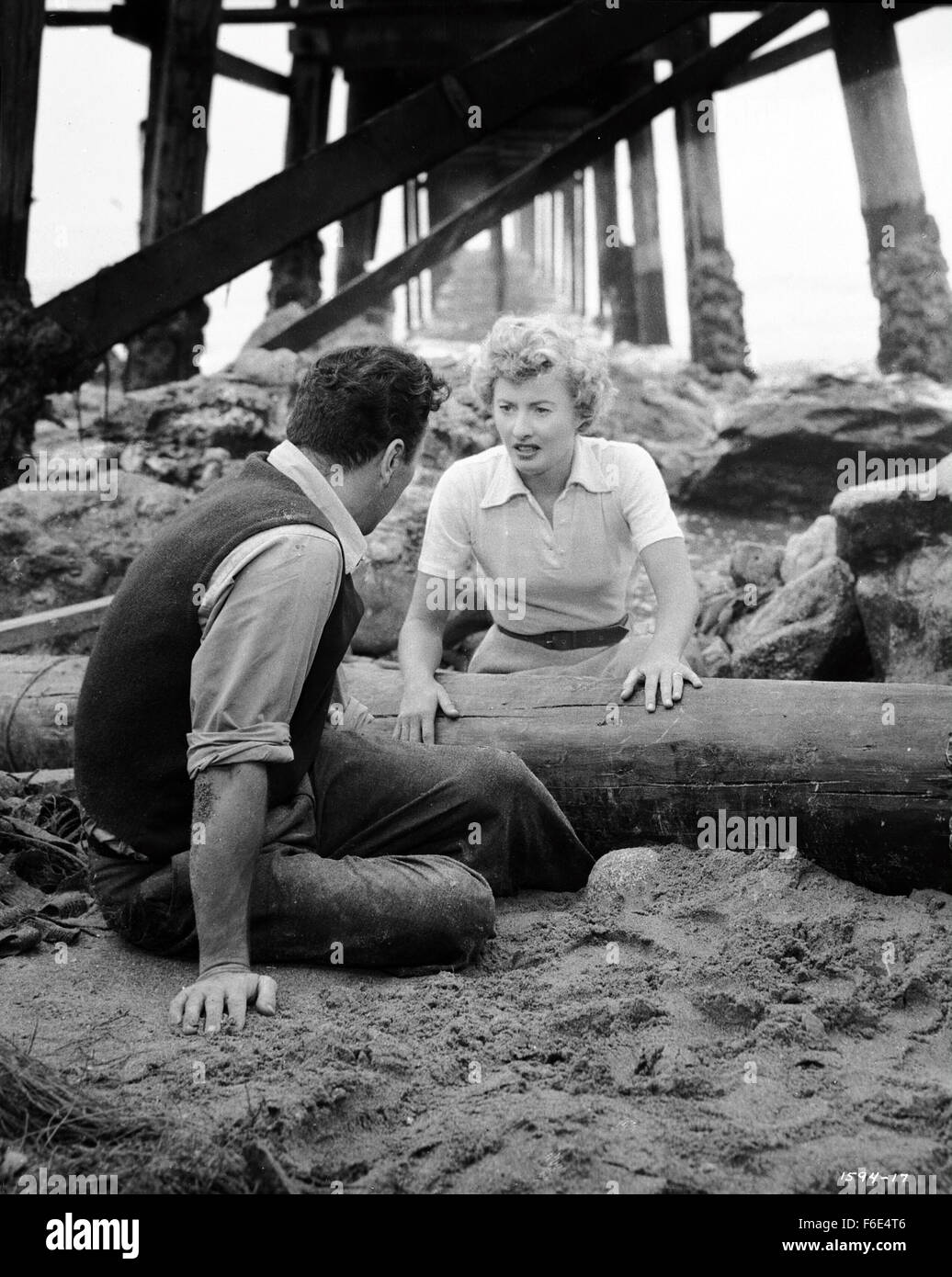 RELEASE DATE: March 30, 1953. MOVIE TITLE: Jeopardy. STUDIO: Metro-Goldwyn-Mayer (MGM). PLOT: The Stilwins are on vacation to an isolated beach in Mexico. Walking on a deserted jetty, Doug Stilwin gets his leg trapped under one of the logs. All attempts to move the log are futile and Helen Stilwin takes the car to get help. However, an escaped criminal kidnaps her. Will she be able to return to her husband before he drowns? PICTURED: BARBARA STANWYCK as Helen Stilwin and BARRY SULLIVAN as Doug Stilwin. Stock Photo