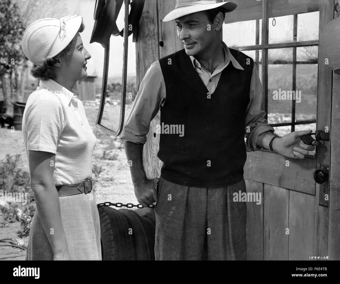 RELEASE DATE: March 30, 1953. MOVIE TITLE: Jeopardy. STUDIO: Metro-Goldwyn-Mayer (MGM). PLOT: The Stilwins are on vacation to an isolated beach in Mexico. Walking on a deserted jetty, Doug Stilwin gets his leg trapped under one of the logs. All attempts to move the log are futile and Helen Stilwin takes the car to get help. However, an escaped criminal kidnaps her. Will she be able to return to her husband before he drowns? PICTURED: BARBARA STANWYCK as Helen Stilwin and BARRY SULLIVAN as Doug Stilwin. Stock Photo