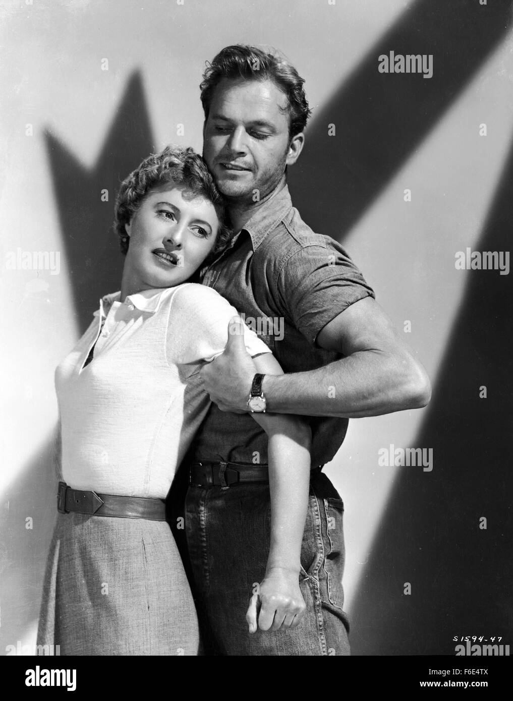 RELEASE DATE: March 30, 1953. MOVIE TITLE: Jeopardy. STUDIO: Metro-Goldwyn-Mayer (MGM). PLOT: The Stilwins are on vacation to an isolated beach in Mexico. Walking on a deserted jetty, Doug Stilwin gets his leg trapped under one of the logs. All attempts to move the log are futile and Helen Stilwin takes the car to get help. However, an escaped criminal kidnaps her. Will she be able to return to her husband before he drowns? PICTURED: BARBARA STANWYCK as Helen Stilwin and RALPH MEEKER as Lawson, the Fugitive. Stock Photo