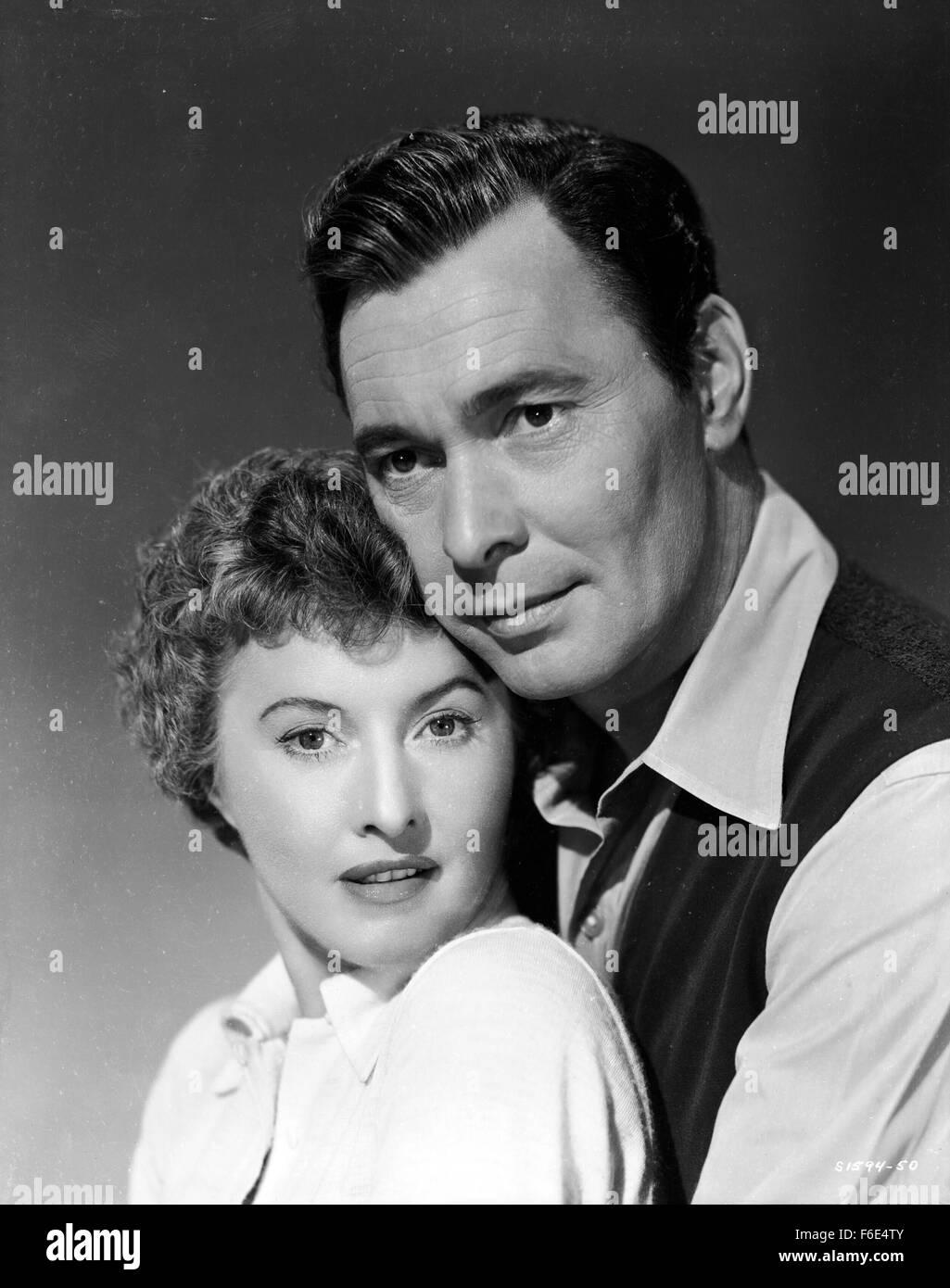 RELEASE DATE: March 30, 1953. MOVIE TITLE: Jeopardy. STUDIO: Metro-Goldwyn-Mayer (MGM). PLOT: The Stilwins are on vacation to an isolated beach in Mexico. Walking on a deserted jetty, Doug Stilwin gets his leg trapped under one of the logs. All attempts to move the log are futile and Helen Stilwin takes the car to get help. However, an escaped criminal kidnaps her. Will she be able to return to her husband before he drowns? PICTURED: BARBARA STANWYCK as Helen Stilwin and BARRY SULLIVAN as Doug Stilwin. Stock Photo
