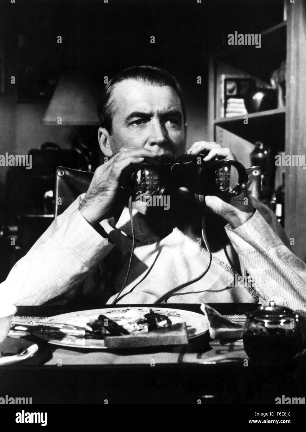 Film Title:  REAR WINDOW.  DIRECTOR:  Alfred Hitchcock.  STUDIO:  Paramount Pictures.  PLOT:  Confined to a wheelchair while recuperating from a leg break,  photographer 'Jeff' Jeffries (James Stewart) becomes a voyeur, observing the inhabitants of a neighboring building through his 'rear window.'  When he begins to suspect that one of his neighbors has committed murder,  Jeff enlists the help of his fashion model 'society girl' fiancee Lisa Freemont, (Grace Kelly) and his nurse Stella (Thelma Ritter) to investigate.  PICTURED:  JAMES STEWART. Stock Photo