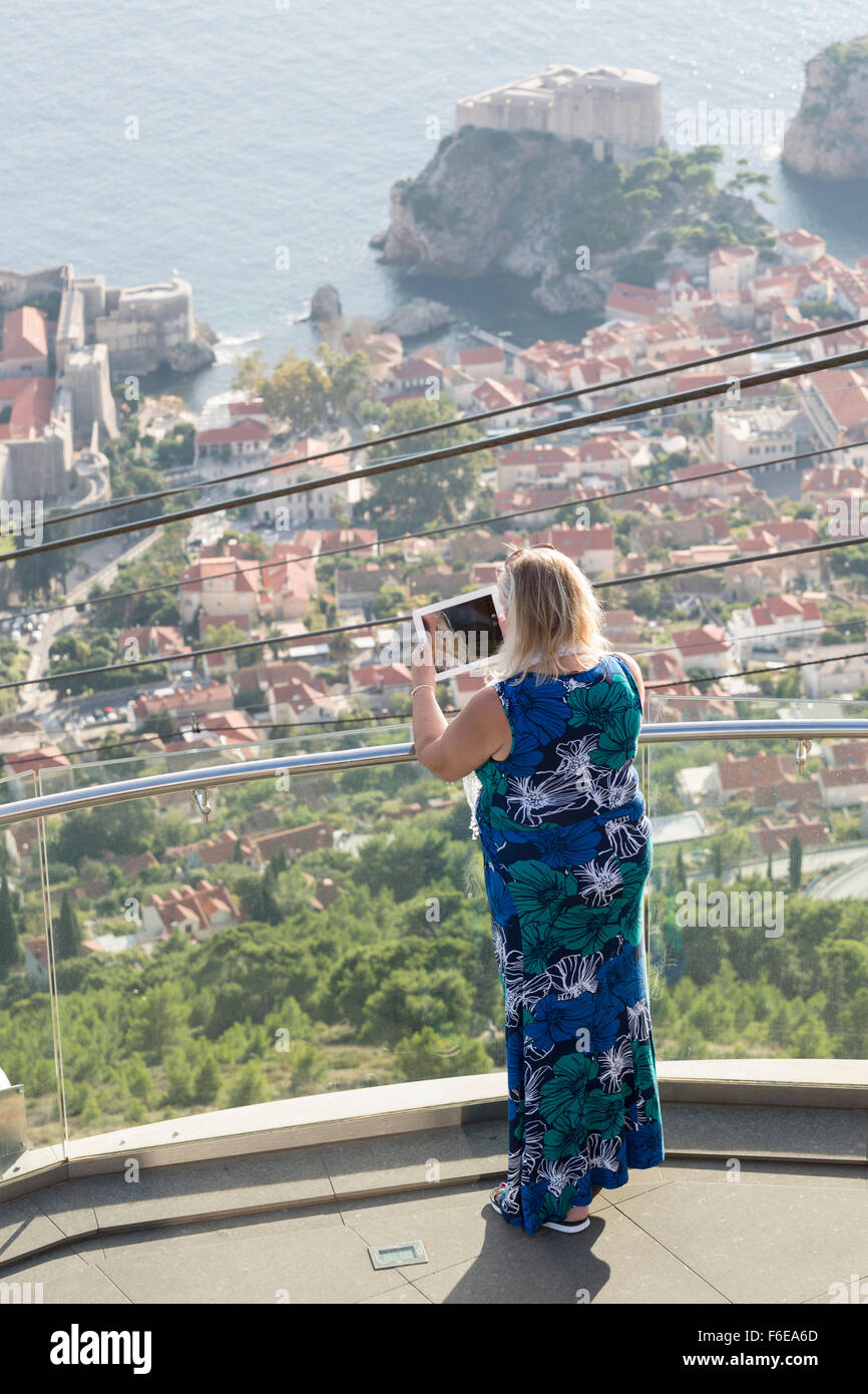 Woman taking photo with iPad, Mt Srd lookout, Dubrovnik, Croatia Stock Photo