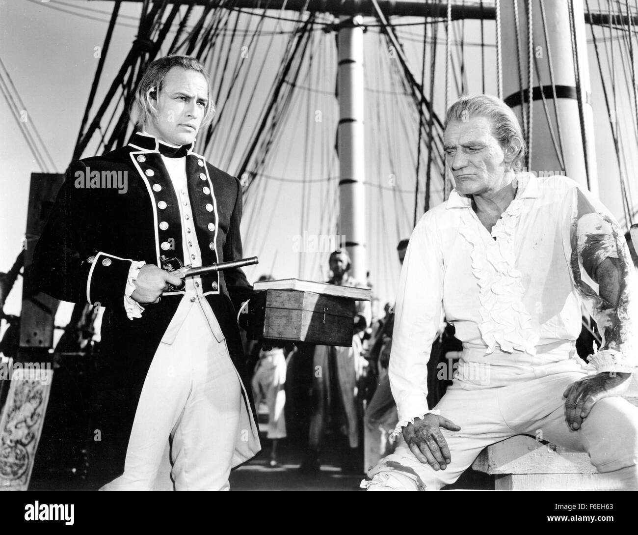 RELEASE DATE: November 8, 1962. MOVIE TITLE: Mutiny on the Bounty. STUDIO: Metro-Goldwyn-Mayer (MGM). PLOT: The Bounty leaves Portsmouth in 1787. Its destination: to sail to Tahiti and load bread-fruit. Captain Bligh will do anything to get there as fast as possible, using any means to keep up a strict discipline. When they arrive at Tahiti, it is like a paradise for the crew, something completely different than the living hell on the ship. On the way back to England, officer Fletcher Christian becomes the leader of a mutiny. PICTURED: MARLON BRANDO as 1st Lt. Fletcher Christian and TREVOR HOW Stock Photo