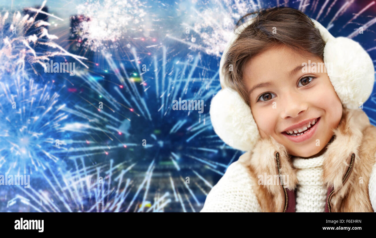 happy little girl wearing earmuffs over firework Stock Photo Alamy