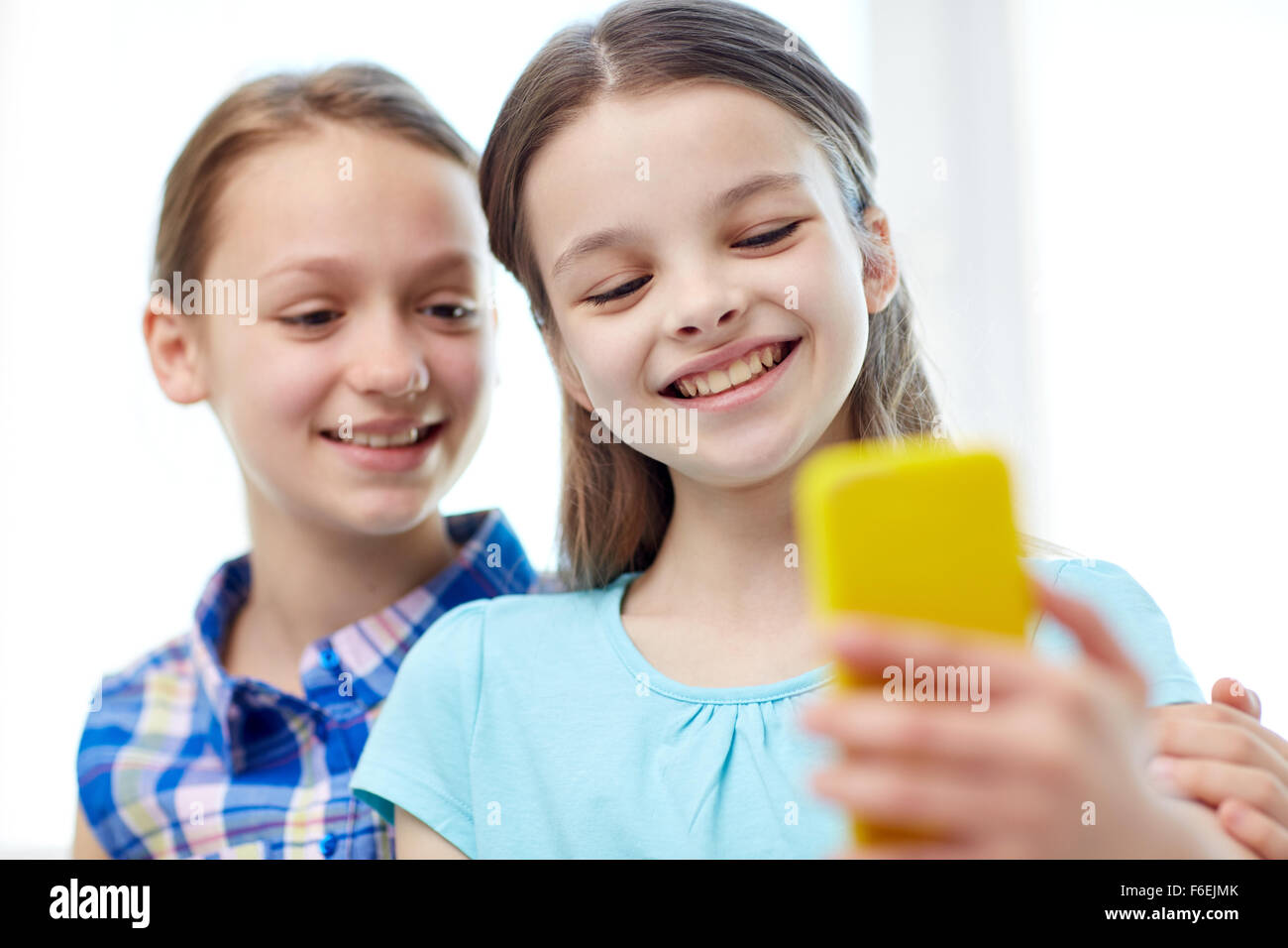 happy girls with smartphone taking selfie at home Stock Photo - Alamy