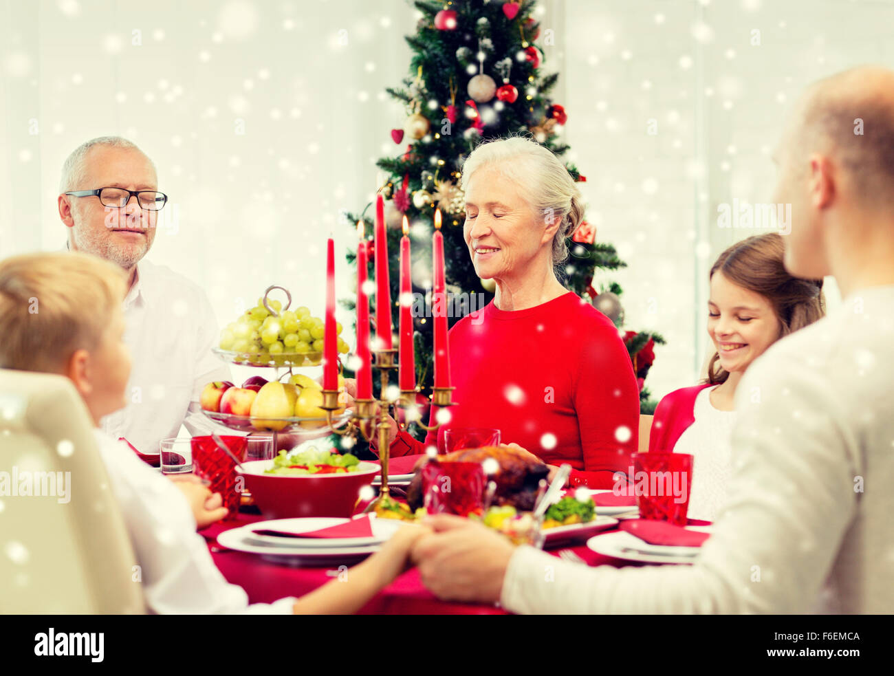 smiling family having holiday dinner at home Stock Photo - Alamy