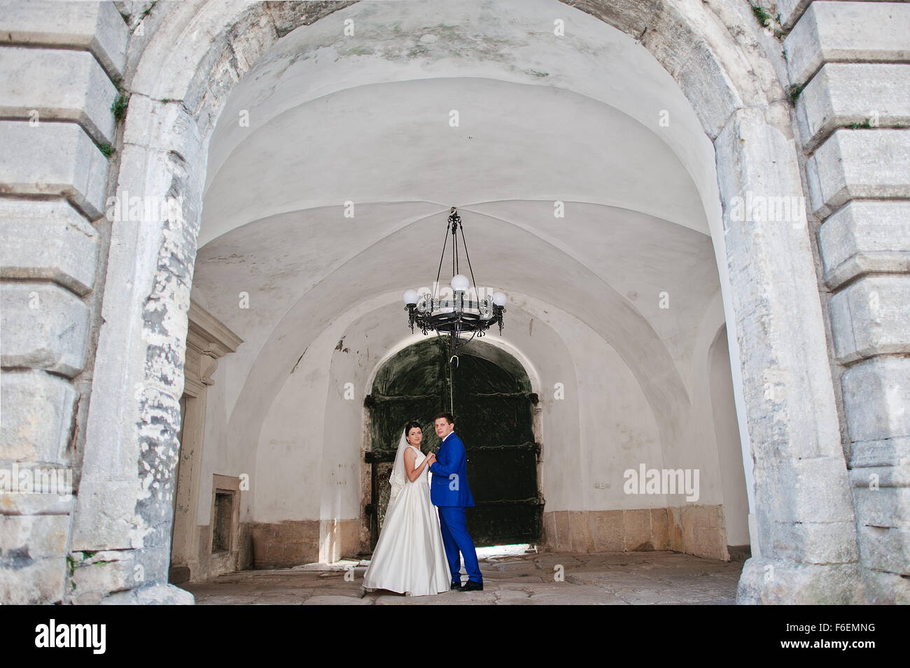 Young wedding couple on background old castle Stock Photo - Alamy