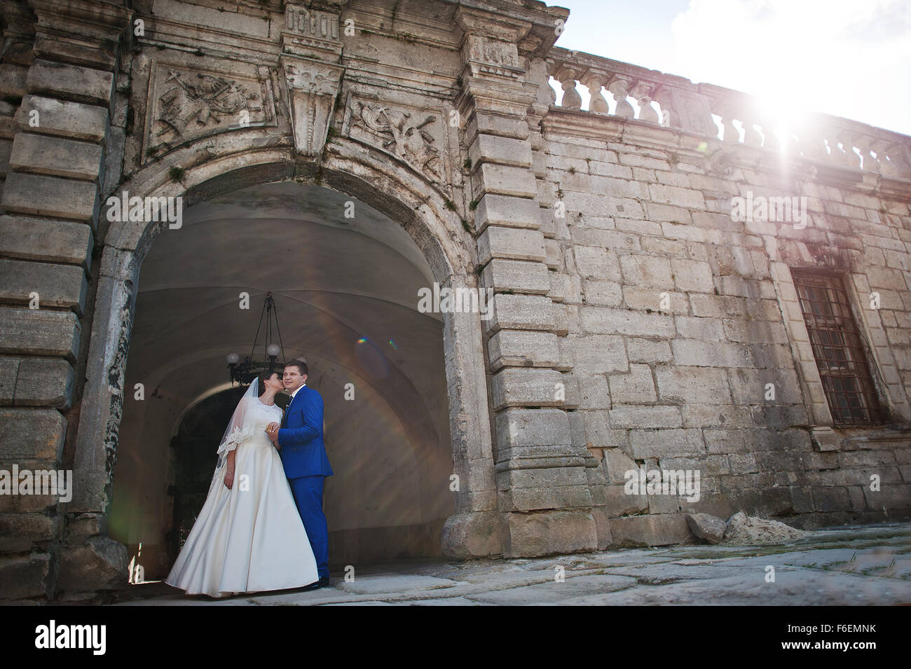 Young wedding couple on background old castle Stock Photo - Alamy
