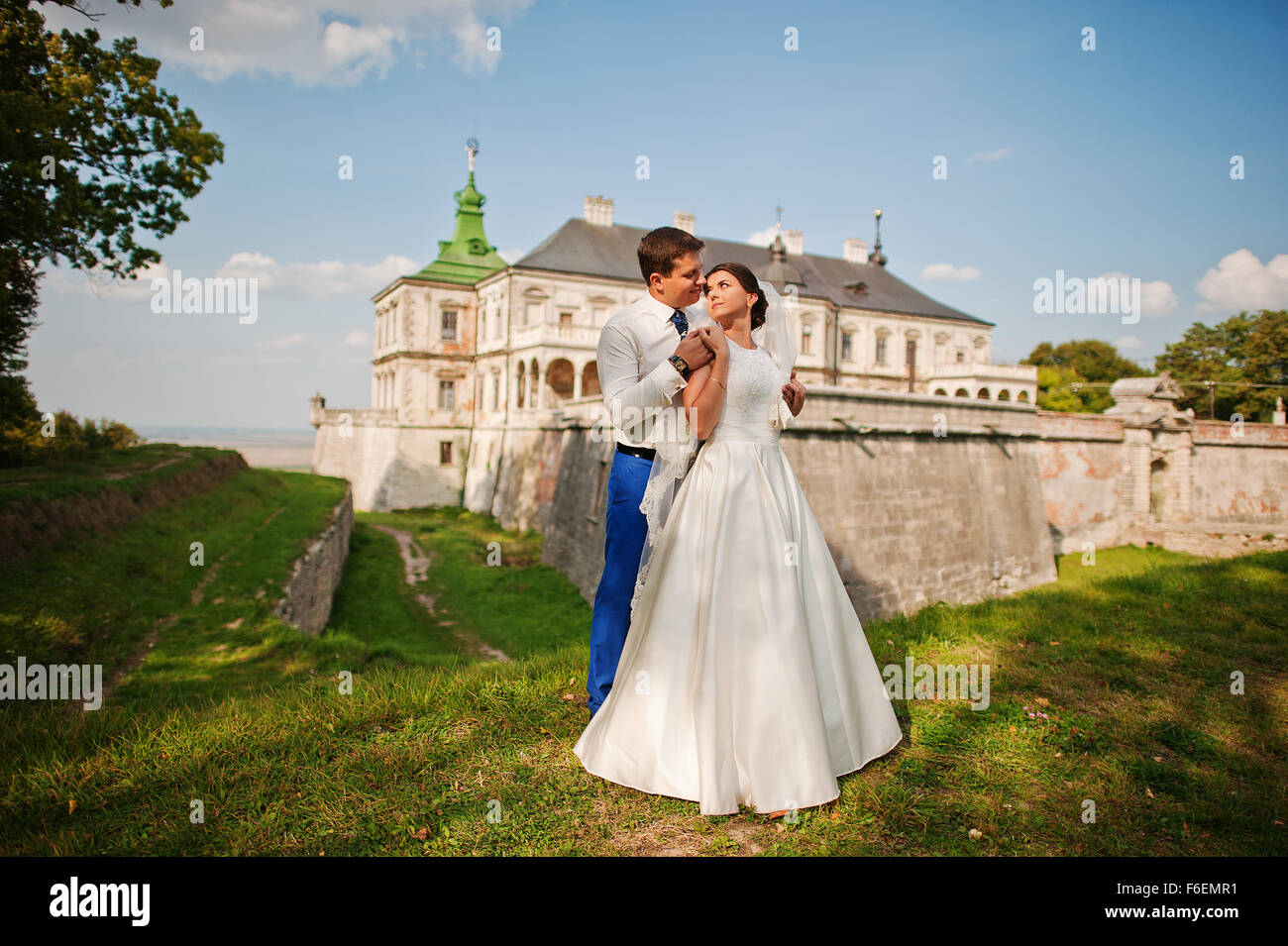 Young wedding couple on background old castle Stock Photo - Alamy