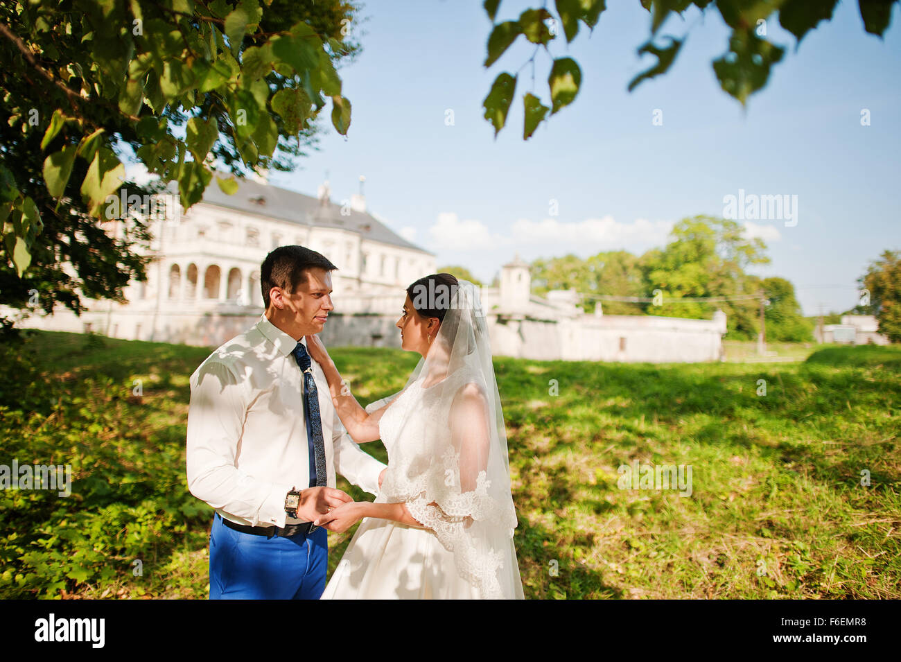 Young wedding couple on background old castle Stock Photo - Alamy
