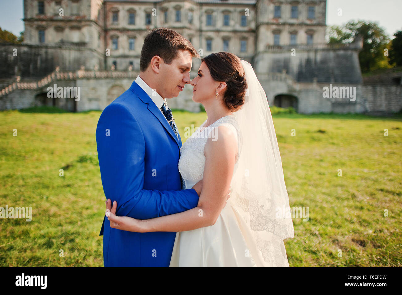 Young wedding couple on background old castle Stock Photo - Alamy