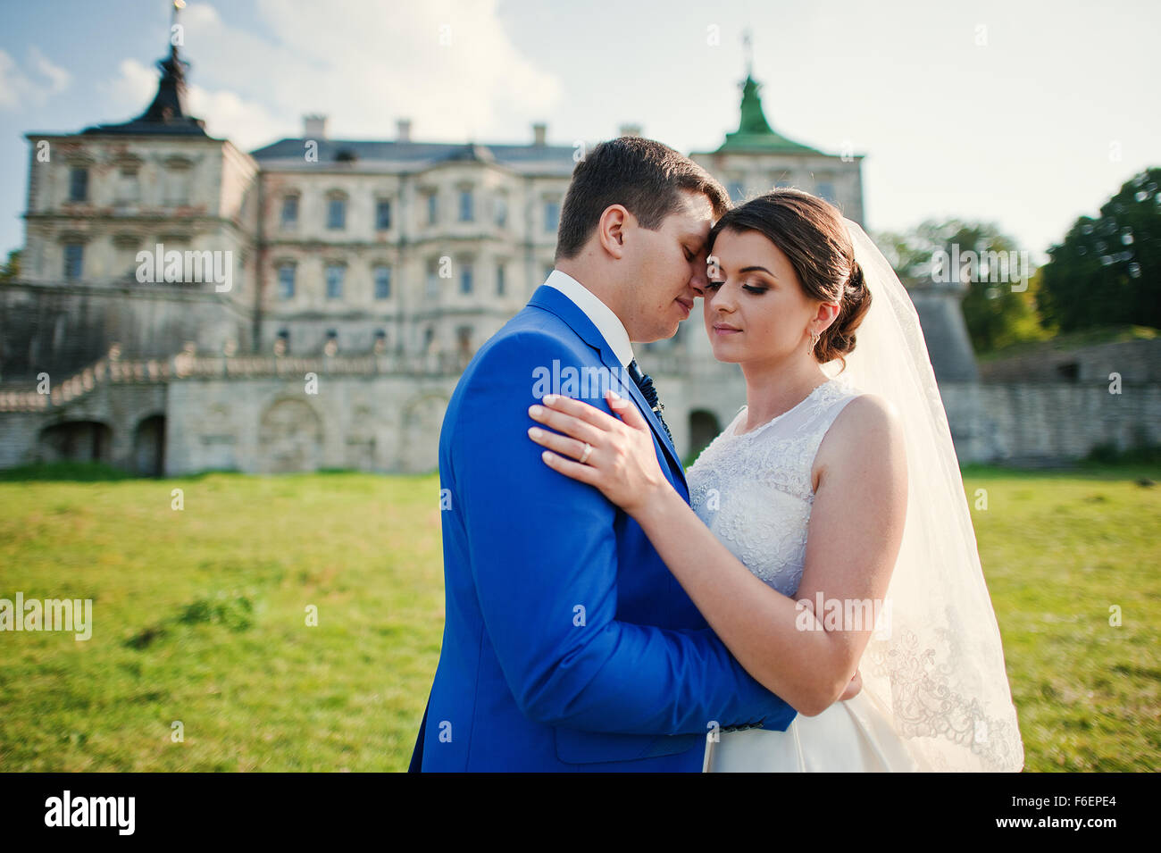 Young wedding couple on background old castle Stock Photo - Alamy
