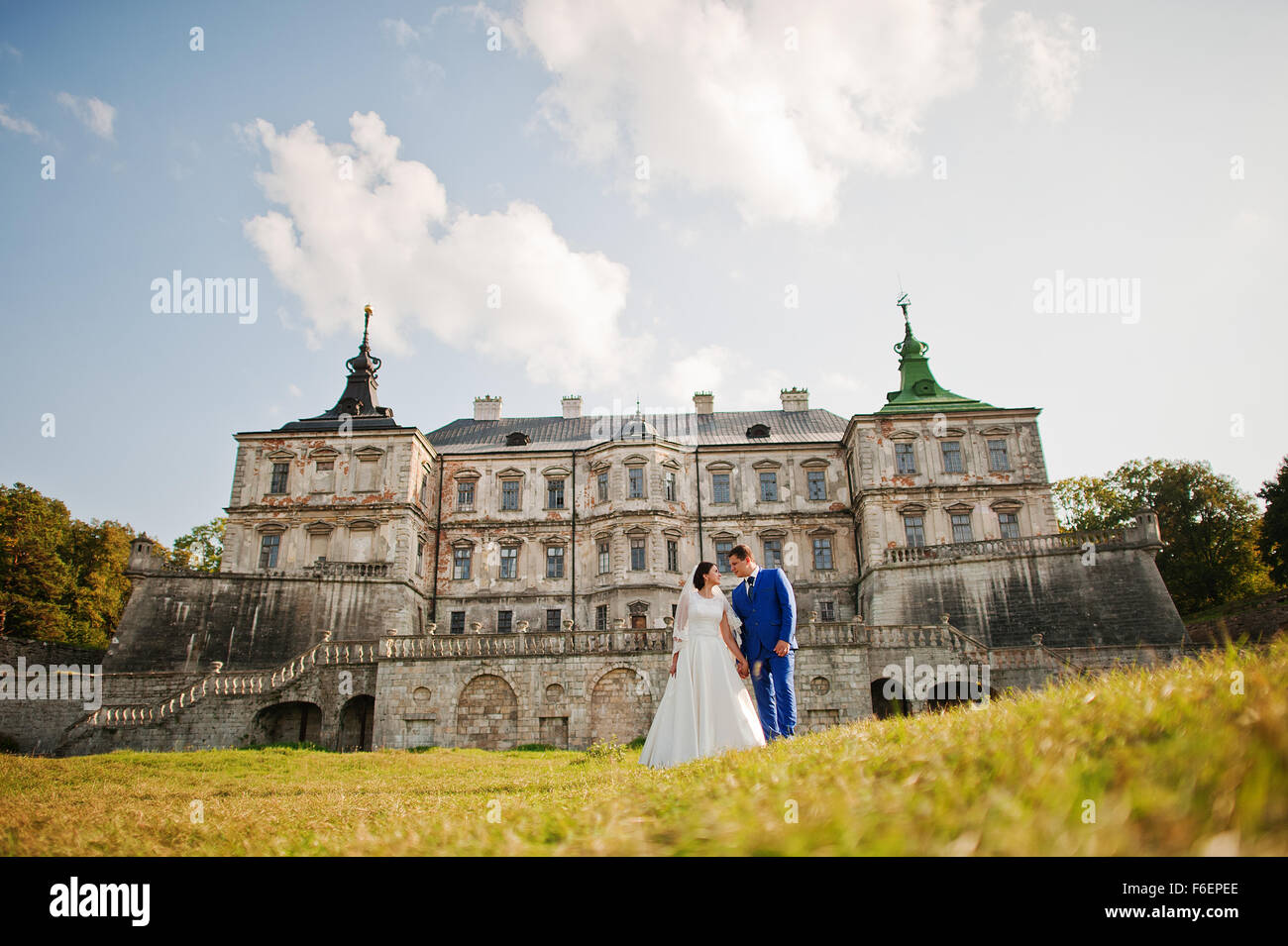 Young wedding couple on background old castle Stock Photo - Alamy