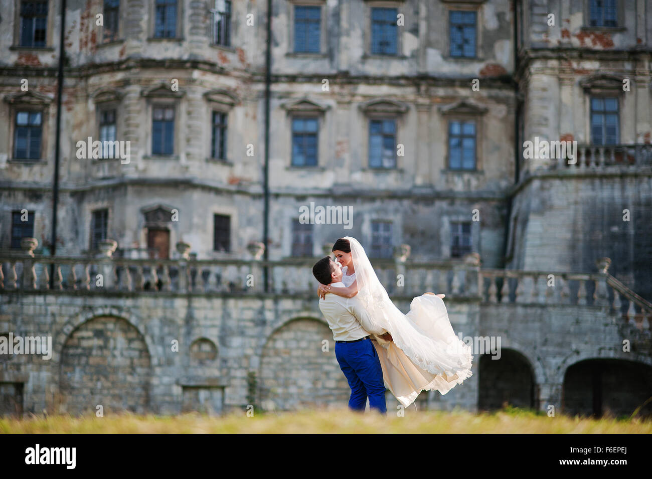 Young wedding couple on background old castle Stock Photo - Alamy
