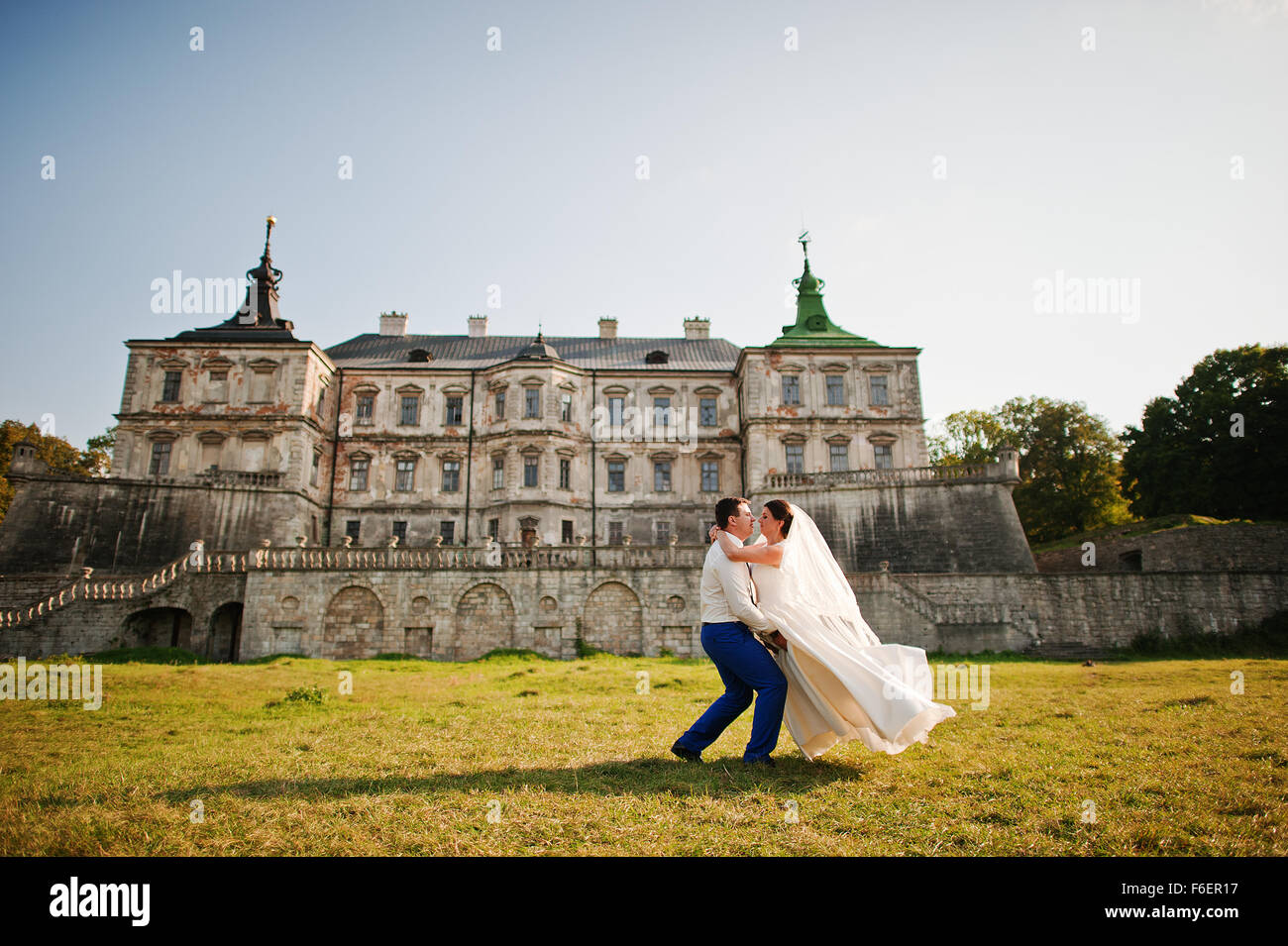 Young wedding couple on background old castle Stock Photo - Alamy